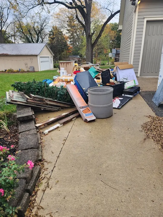 Dumpster being loaded with debris for 3 Yard Dumpster Rental in College